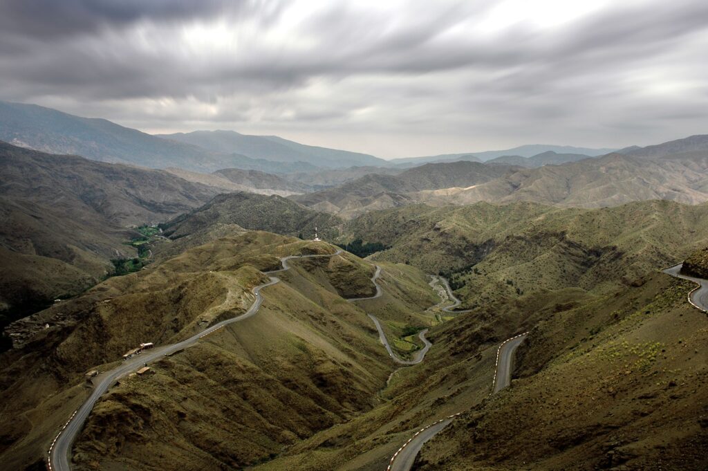 A scenic view of winding roads in the High Atlas Mountains near Ouarzazate, Morocco.